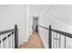 Second floor hallway with carpet and white railing leading to a bedroom in a house at 555 Pointe Of Oaks Rd, Summerville, SC 29485