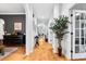 Spacious hallway with hardwood floors and neutral walls, leading to various rooms in the home, creating flow at 555 Pointe Of Oaks Rd, Summerville, SC 29485