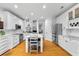 Bright kitchen with white cabinets, marble countertops, stainless steel appliances, and hardwood floors at 555 Pointe Of Oaks Rd, Summerville, SC 29485
