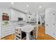 Bright kitchen with white cabinets, marble countertops, stainless steel appliances, and hardwood floors at 555 Pointe Of Oaks Rd, Summerville, SC 29485