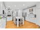 Bright kitchen with white cabinets, marble countertops, stainless steel appliances, and hardwood floors at 555 Pointe Of Oaks Rd, Summerville, SC 29485