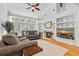 Bright living room with a fireplace, built-in shelving, and comfortable seating, perfect for Gathering gatherings at 555 Pointe Of Oaks Rd, Summerville, SC 29485