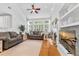 Inviting living room with plush sofas, large windows, and a fireplace, creating a warm and welcoming space at 555 Pointe Of Oaks Rd, Summerville, SC 29485