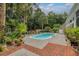 The backyard pool is accentuated with surrounding brickwork and lush landscaping, creating a private outdoor retreat at 555 Pointe Of Oaks Rd, Summerville, SC 29485
