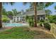 The outdoor pool area is enhanced by a verdant garden featuring palm trees and meticulously arranged plants at 555 Pointe Of Oaks Rd, Summerville, SC 29485