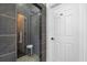 Modern shower with tile surround, glass doors, and contemporary fixtures at 555 Pointe Of Oaks Rd, Summerville, SC 29485
