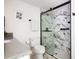 A pristine bathroom highlighting a marble-tiled shower with a glass door and sleek fixtures at 5814 Knight St, Hanahan, SC 29410