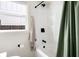 Bathroom showcasing a tub-shower combo, white fixtures, and a neutral-toned color scheme at 5814 Knight St, Hanahan, SC 29410
