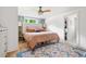 Bright bedroom featuring a light-colored padded headboard, wood floors, and a unique butterfly patterned rug at 5814 Knight St, Hanahan, SC 29410
