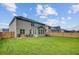 Spacious backyard with green lawn, wooden fence, and patio area at 596 Dunswell Dr, Summerville, SC 29486