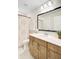 Bright bathroom featuring wood vanity, white countertop, framed mirror, and decorative shower curtain at 596 Dunswell Dr, Summerville, SC 29486
