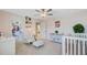 Bright Bedroom with pink accents, a crib, rocking chair, and closet access at 596 Dunswell Dr, Summerville, SC 29486