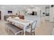 Open-concept dining area with a long table, bench seating, and easy access to the living room and kitchen at 596 Dunswell Dr, Summerville, SC 29486
