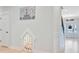 Bright hallway with white trim, hardwood floors, and a cute dog house under the wall art at 596 Dunswell Dr, Summerville, SC 29486