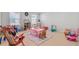 Spacious playroom with multiple windows, neutral walls, light floors, and table at 596 Dunswell Dr, Summerville, SC 29486