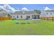 Large backyard with a fire pit and blue chairs at 6179 Fieldstone Cir, Charleston, SC 29414