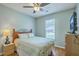 Comfortable bedroom with natural light, ceiling fan, and TV at 6179 Fieldstone Cir, Charleston, SC 29414