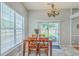 Bright dining area with wooden table and chairs, natural light from sliding glass door and window at 6179 Fieldstone Cir, Charleston, SC 29414
