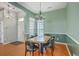 This cozy dining room boasts hard wood floors, wainscoting, and modern lighting at 6179 Fieldstone Cir, Charleston, SC 29414