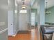 Open foyer featuring wood flooring, modern lighting, and views into the dining and living areas at 6179 Fieldstone Cir, Charleston, SC 29414