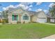Attractive single-story home featuring a green lawn, an attached garage, and eye-catching green shutters at 6179 Fieldstone Cir, Charleston, SC 29414