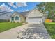 Inviting single-story home with well-maintained lawn, long driveway, and attached two-car garage at 6179 Fieldstone Cir, Charleston, SC 29414