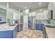 Open kitchen features stainless steel appliances, tile floors, and white and blue cabinets at 6179 Fieldstone Cir, Charleston, SC 29414
