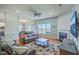 Inviting living area featuring a fireplace, stylish decor, and comfortable seating, open to the kitchen at 6179 Fieldstone Cir, Charleston, SC 29414