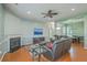 Spacious living room with a corner fireplace, ceiling fan, and open floor plan leading to the dining area at 6179 Fieldstone Cir, Charleston, SC 29414