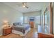 Bright main bedroom with natural light, ceiling fan, and wooden furniture at 6179 Fieldstone Cir, Charleston, SC 29414