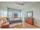 Spacious main bedroom with ample natural light, ceiling fan, and wood floors at 6179 Fieldstone Cir, Charleston, SC 29414