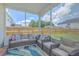 Relaxing screened porch with comfortable seating and a view of the backyard at 6179 Fieldstone Cir, Charleston, SC 29414