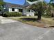 Shot of the front of a home in need of renovation with damaged walls and a front yard at 650 Atlantic St, Mount Pleasant, SC 29464