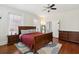 Spacious bedroom with hardwood floors, a large bed, and natural light from two windows at 66 Beaufain St, Charleston, SC 29401
