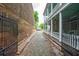 Cobblestone pathway and a lush view of a porch in this charming neighborhood at 66 Beaufain St, Charleston, SC 29401