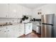 Well-lit kitchen with white cabinets, appliances, and sink, ideal for cooking and food preparation at 66 Beaufain St, Charleston, SC 29401
