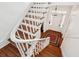 Classic staircase with white railings and wooden steps leading to the front door and foyer at 66 Beaufain St, Charleston, SC 29401