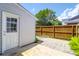 A partially shaded back patio with wooden fencing and exterior door at 680 Buckhall Ct, Mount Pleasant, SC 29464