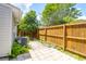 A paver patio with a wooden fence with established green plants at 680 Buckhall Ct, Mount Pleasant, SC 29464