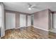 A spacious bedroom features wood-look floors and access to multiple closets and hallway at 680 Buckhall Ct, Mount Pleasant, SC 29464