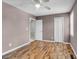 A bright bedroom features wood-look floors, ceiling fan and access to upstairs hallway at 680 Buckhall Ct, Mount Pleasant, SC 29464