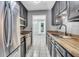 Galley kitchen featuring stainless steel appliances, butcher block countertops, and white tiled floors at 680 Buckhall Ct, Mount Pleasant, SC 29464