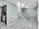 Open-concept living area with tile flooring leading to kitchen and staircase at 680 Buckhall Ct, Mount Pleasant, SC 29464