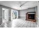 Living room with brick fireplace, white tiled floors, and sliding glass doors at 680 Buckhall Ct, Mount Pleasant, SC 29464
