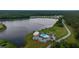 An aerial view of a community lake with a clubhouse, pool, playground, and waterfront homes at 682 Pontoon Rd, Huger, SC 29450