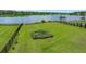Spacious backyard with lush green lawn, garden, and a view of the lake at 682 Pontoon Rd, Huger, SC 29450