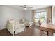Bedroom with twin beds, wood floors, a desk, and a bright window with neighborhood view at 682 Pontoon Rd, Huger, SC 29450