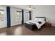 Bedroom with wood floors, blue accent curtains and doors leading to a balcony at 682 Pontoon Rd, Huger, SC 29450