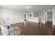Large bonus room with dark wood floors, white trim and seating area at 682 Pontoon Rd, Huger, SC 29450