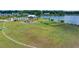 Aerial view of a community with a pool, playground, dog park, and soccer field by a lake at 682 Pontoon Rd, Huger, SC 29450